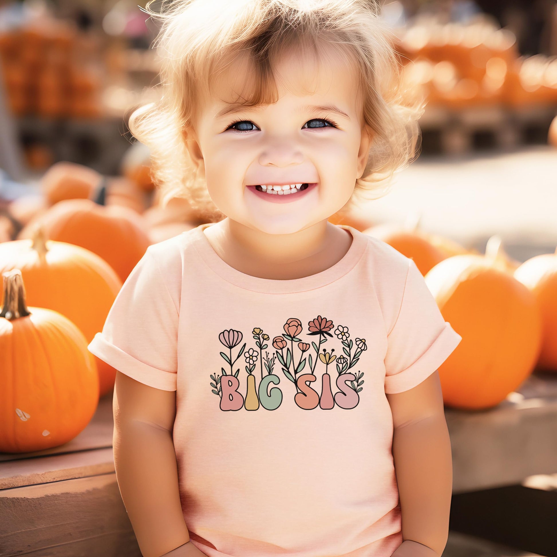 Young girl modeling the big sister floral tee in a lifestyle setting
