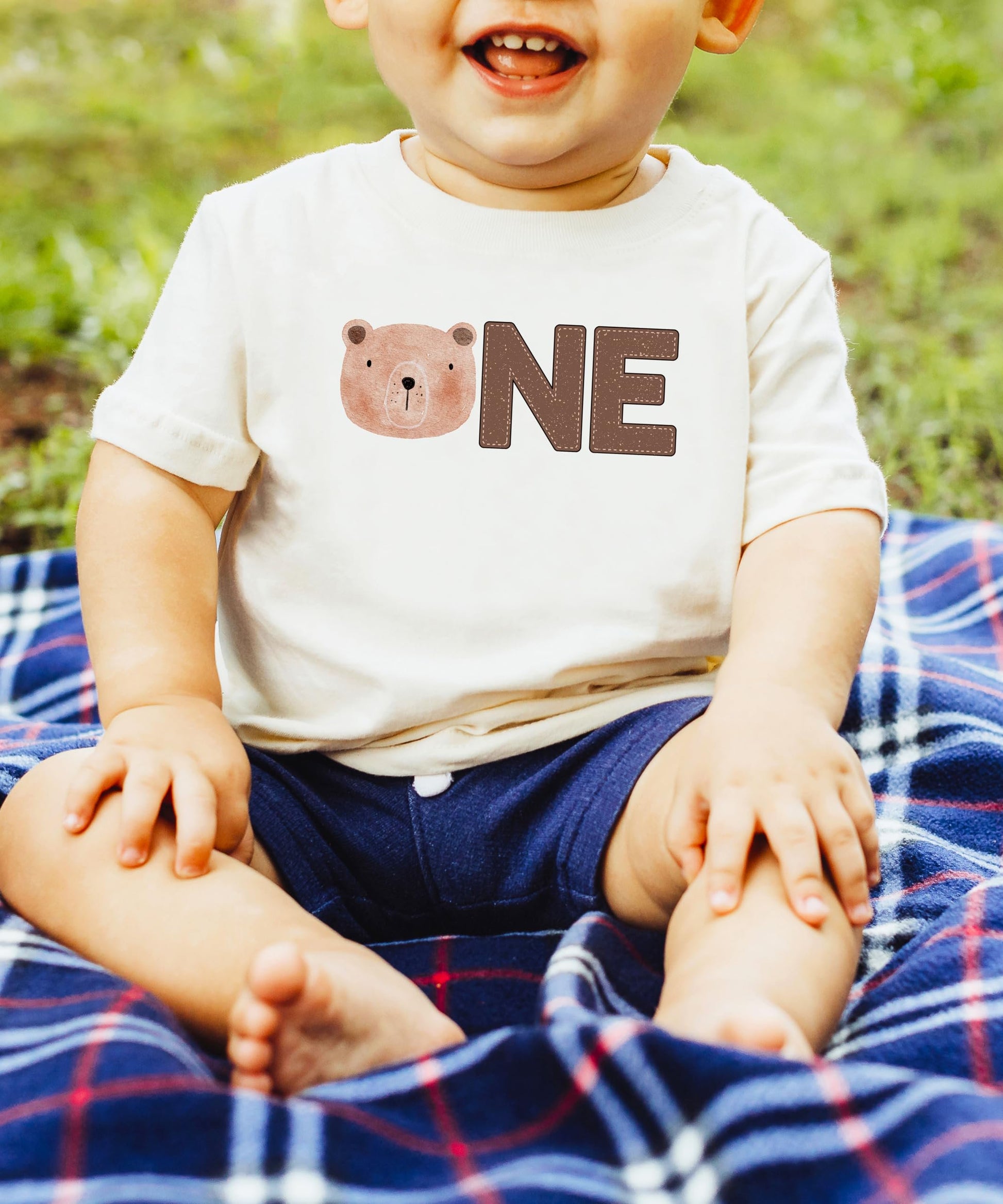 Side view of soft natural first birthday bear graphic tee for boys