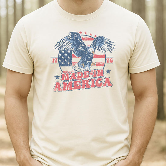 Group flat lay of family matching Made In America patriotic tees in multiple sizes