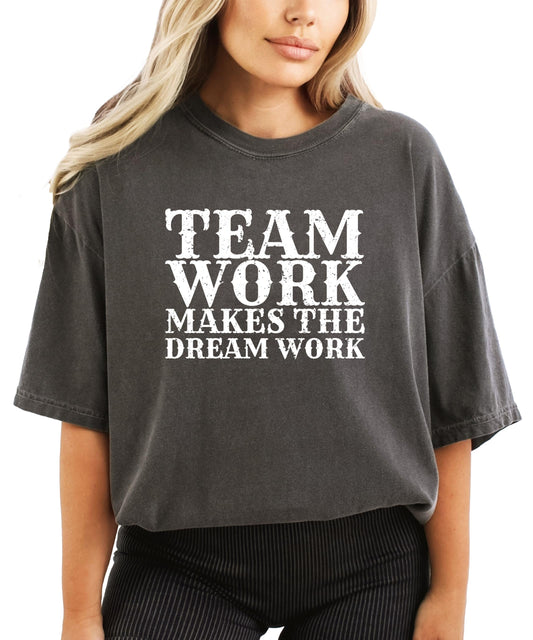 Close-up view of Team Work Makes Dream Work text design on seafoam colored women's tee