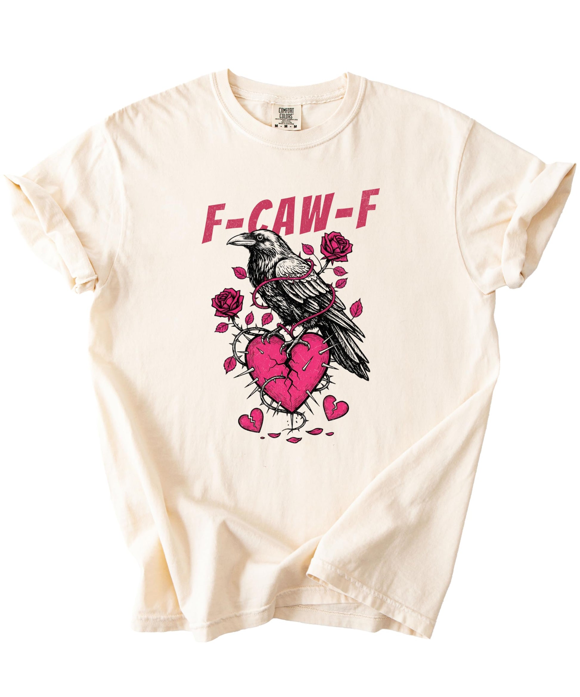 Flat lay of Olive Loves Apple ivory graphic tee with crow and broken heart Valentine's Day design