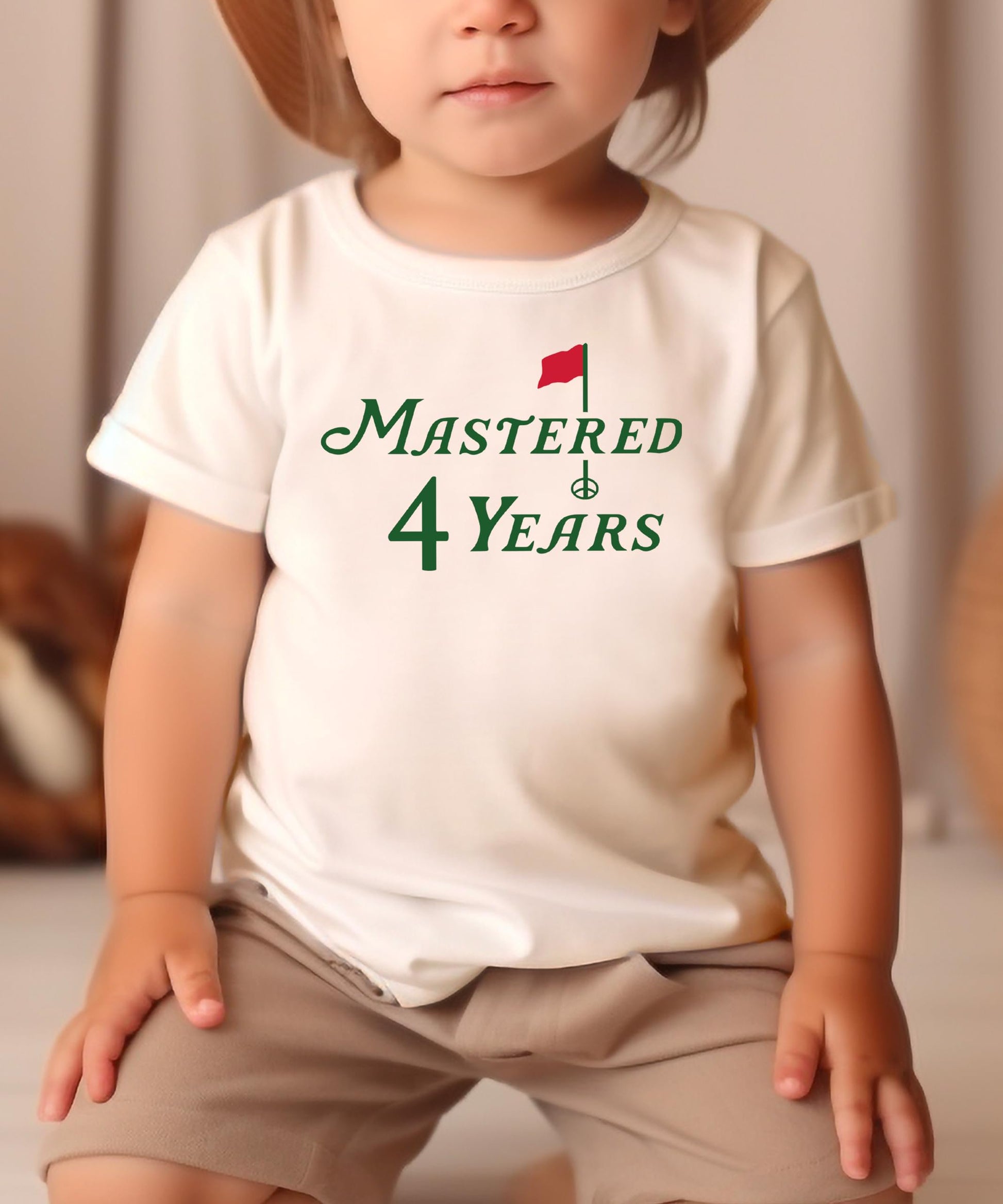 Boy or girl wearing Mastered 4 Years golf themed 4th birthday t-shirt in natural color