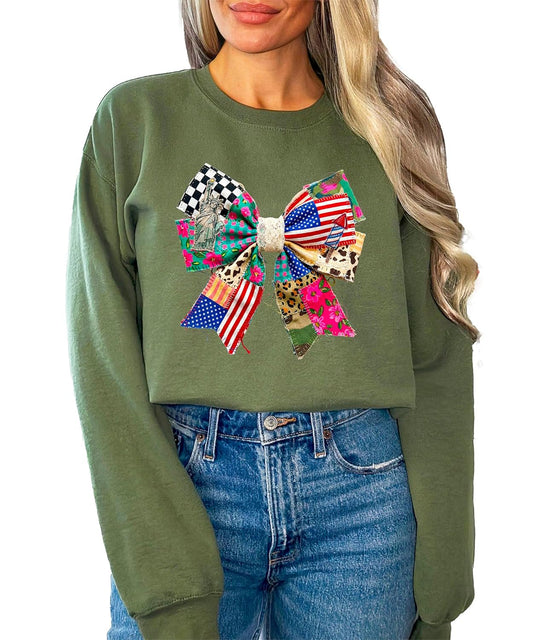 Detail shot of ink-printed bow design on white fleece sweatshirt highlighting stars, stripes, and floral Americana elements