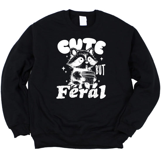Front view of a youth Cute But Feral raccoon graphic sweatshirt in pink