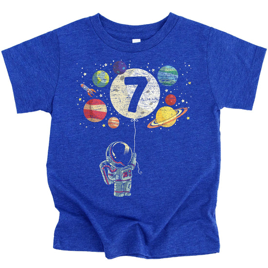 Close-up of astronaut birthday shirt print featuring rocket, moon balloon, and colorful planets