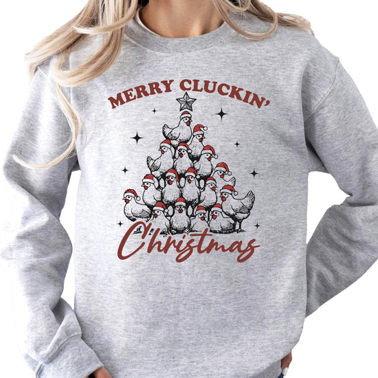 Woman wearing a funny white Christmas pullover sweatshirt with chicken holiday graphic