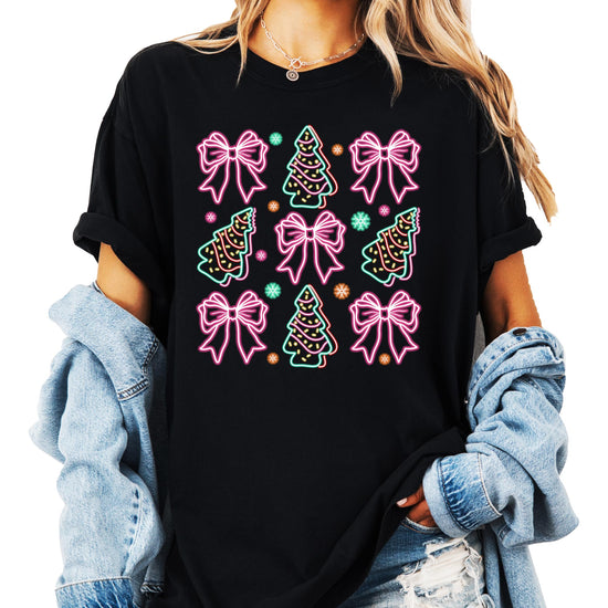 Front view of neon Christmas trees and gift bows graphic tee on black shirt for women and teens