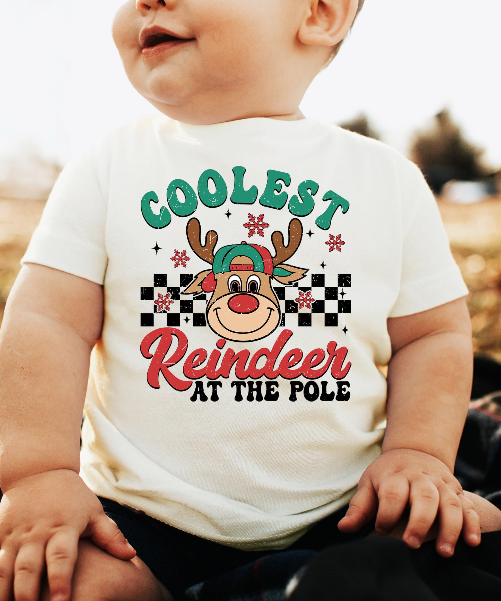 Kids Christmas reindeer shirt detail shot showing vibrant USA-printed graphic on natural tee