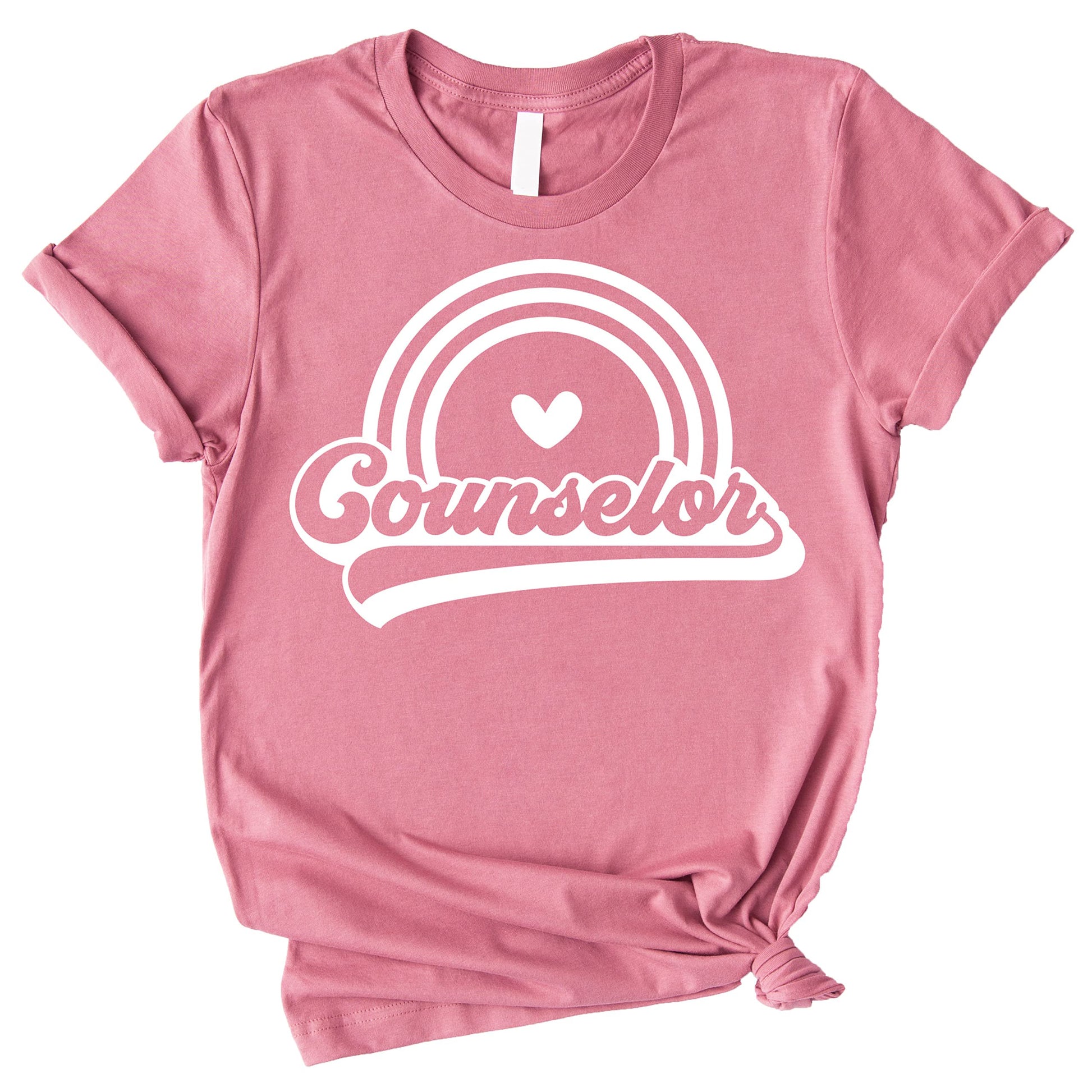 Close-up of retro rainbow counselor shirt print, vibrant colorful graphic on peach tee
