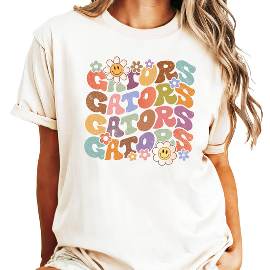 Detail shot of retro groovy GATORS lettering and floral smiley graphic tee design
