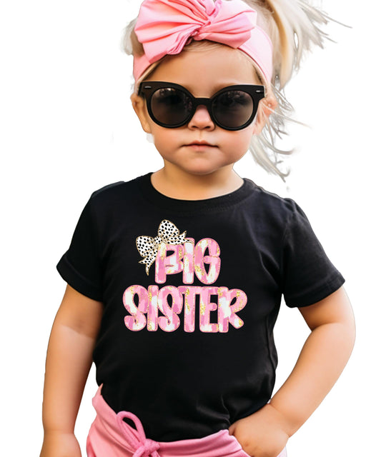 Close-up of Big Sister leopard bow print on black kids graphic tee