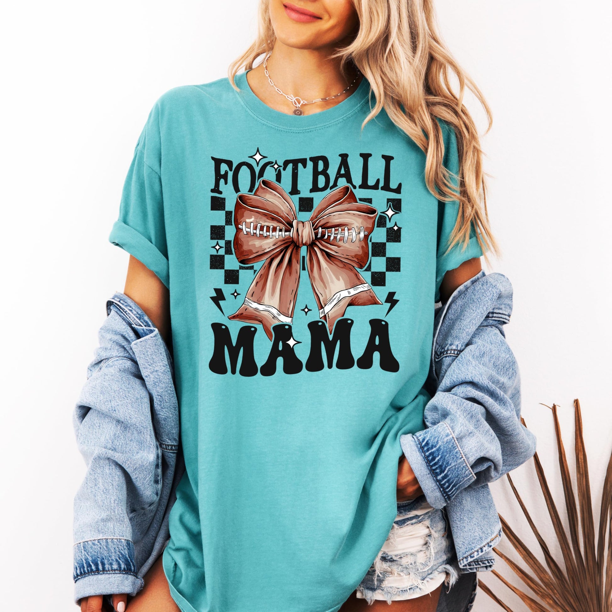 Detail shot of coquette bow retro football graphic on ivory adult women's shirt