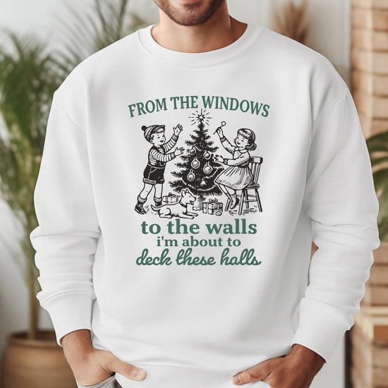 Model wearing Deck These Halls gray Christmas sweatshirt styled casually for holiday season