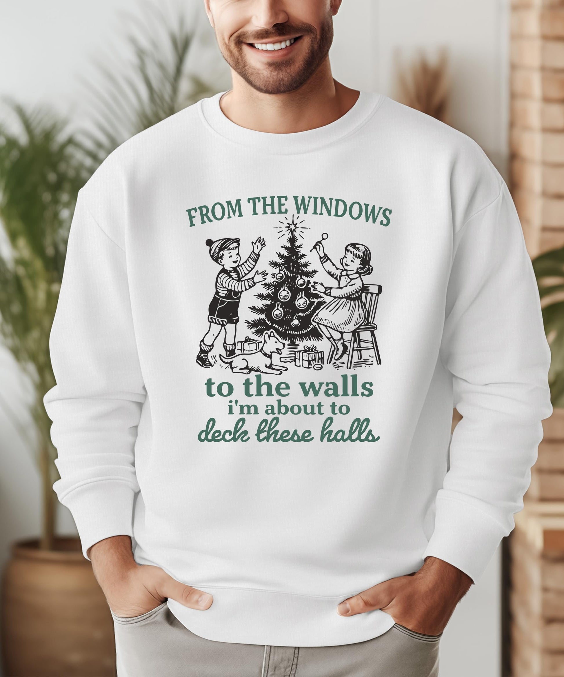 Model wearing Deck These Halls gray Christmas sweatshirt styled casually for holiday season
