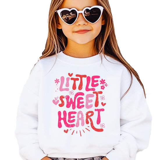 Close-up of pink hearts and flowers graphic print on girls' Valentine sweatshirt
