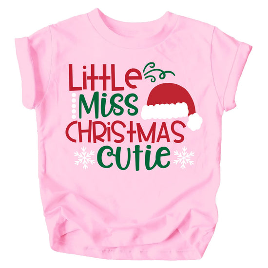 Toddler girl wearing Little Miss Christmas Cutie peach graphic t-shirt for Christmas