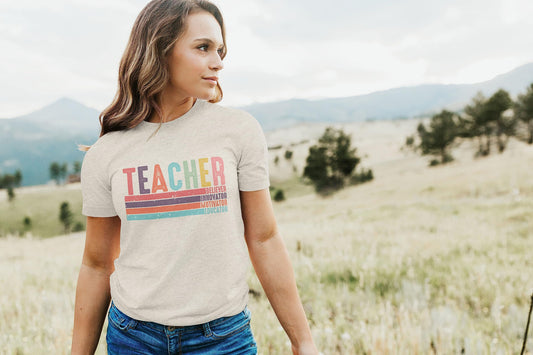 Olive Loves Apple colorful teacher appreciation graphic tee laid flat