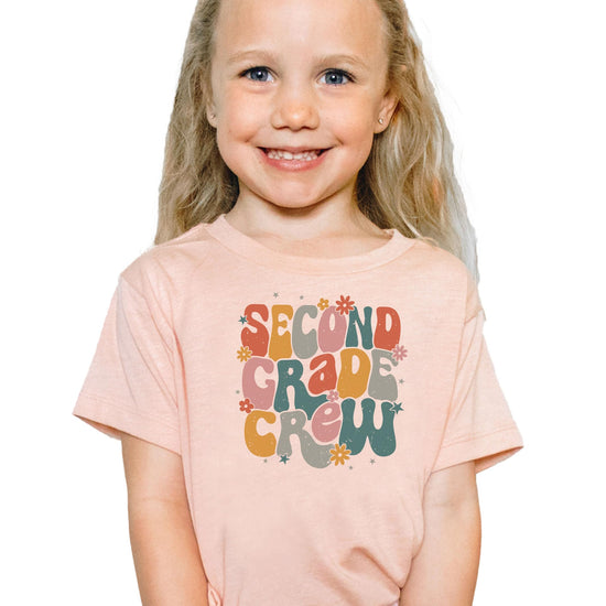 Women's version of retro second grade vintage flower school tee laid flat