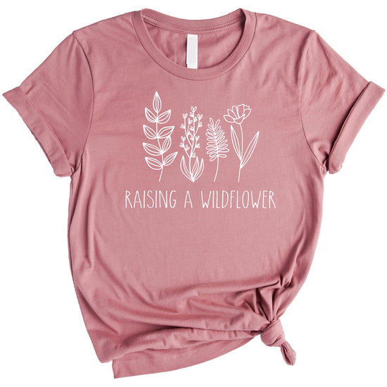 Mom and child wearing matching mauve raising wildflowers graphic tees