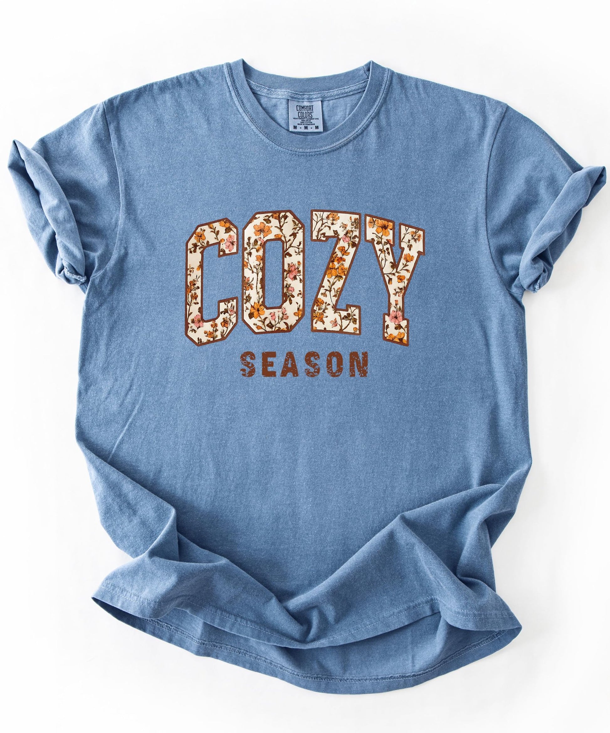 Detail shot of high-quality print on Cozy Season orange floral women's tee