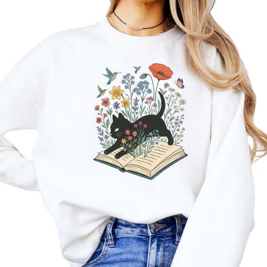Youth size white sweatshirt featuring black cat and floral open book design for kids who love reading