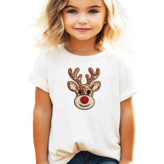 Close-up of ink-printed reindeer holiday graphic on black girls shirt showing shimmer detail