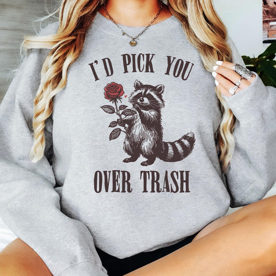 Family matching Valentine's Day sweatshirts with raccoon graphic displayed together in women's and kids sizes
