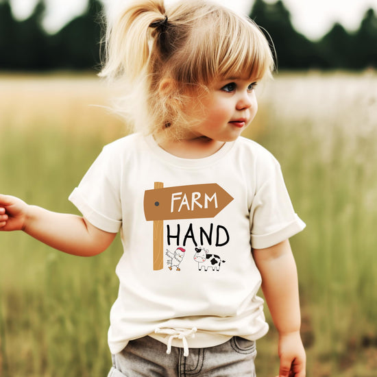 Front view of unisex kids farm graphic tee with cow and chicken design on natural fabric