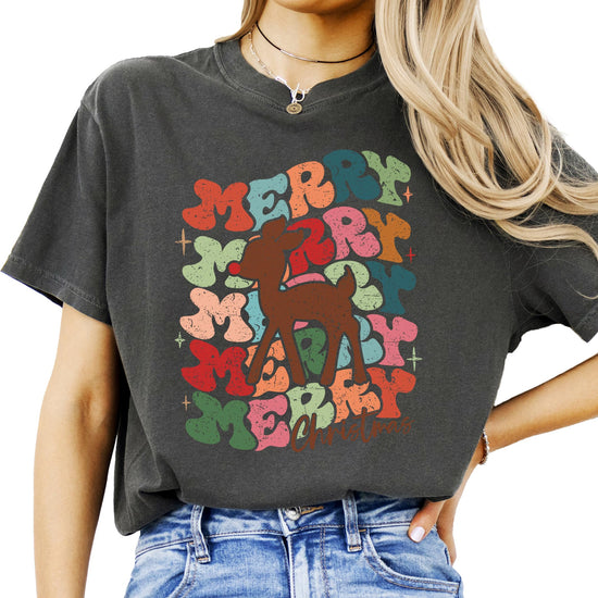 Women's retro Merry Christmas graphic tee with groovy red-nosed reindeer design in festive holiday colors