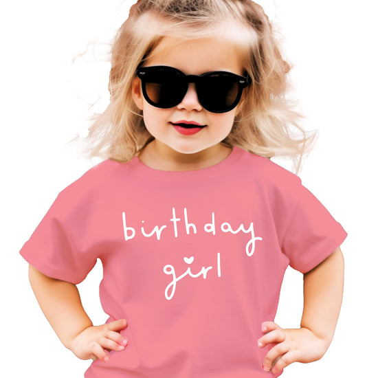 Young girl wearing military green Birthday Girl heart graphic tee for birthday celebration