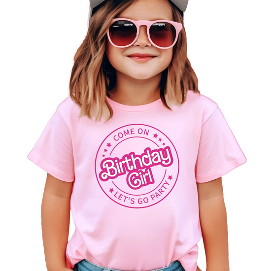 Flat lay of kids pink birthday girl graphic tee with retro party design