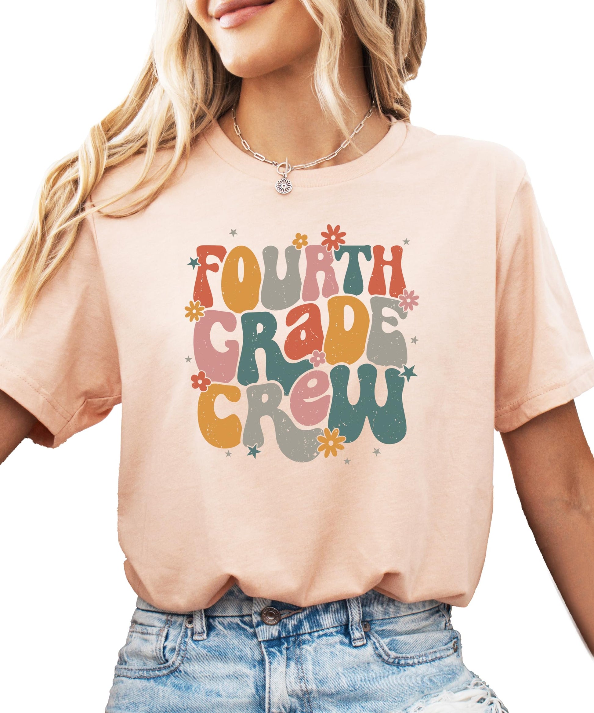 Close-up of Fourth Grade Crew retro lettering on peach kids t-shirt