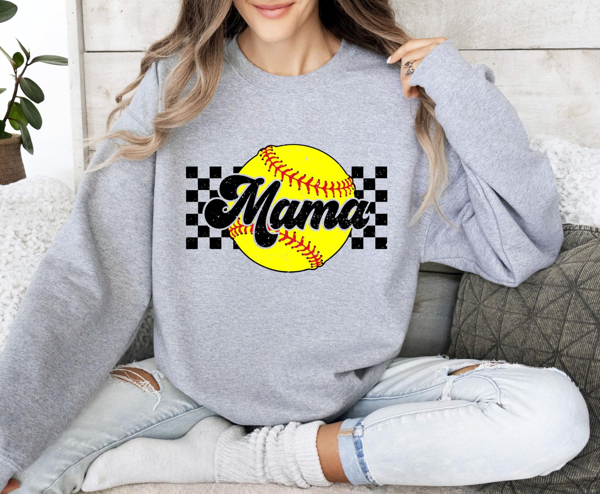 Woman wearing Softball Mama sweatshirt, perfect for gameday and sports moms