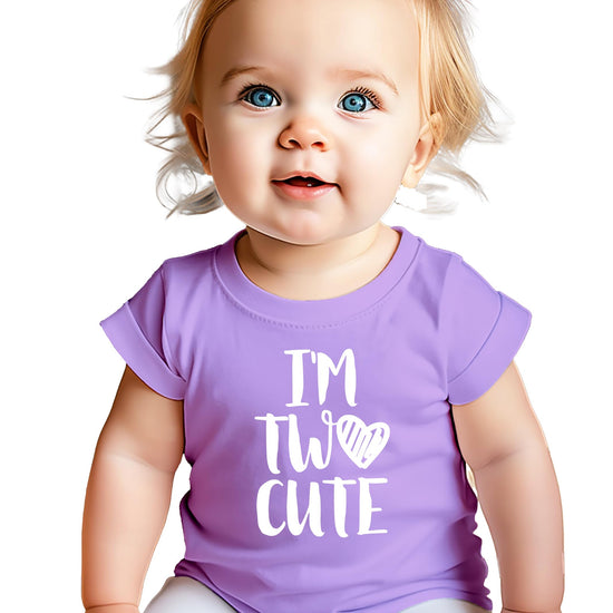 Toddler girl wearing mauve I'm Two Cute second birthday shirt with white graphic print