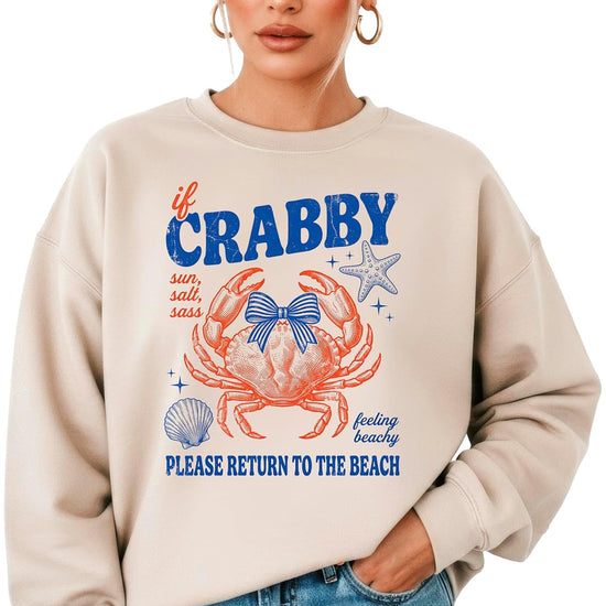 Family wearing matching 'If Crabby Please Return to the Beach' white crewneck sweatshirts in adult and youth sizes