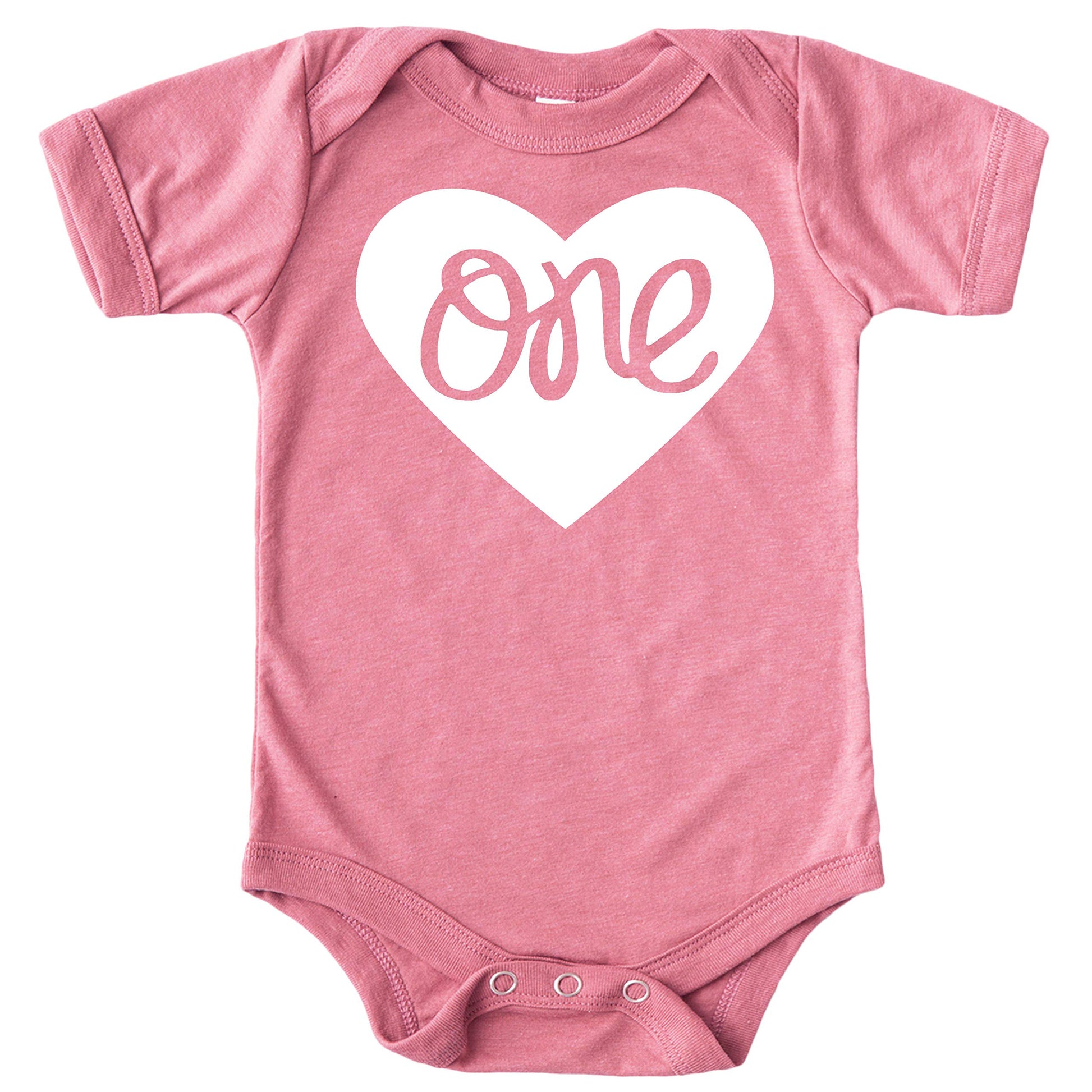 Close-up of One in a Heart first birthday bodysuit design on military green baby girl snap bodysuit