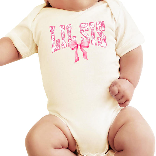 Natural baby bodysuit with floral 'Lil Sis' lettering and pink bow accent for little sister
