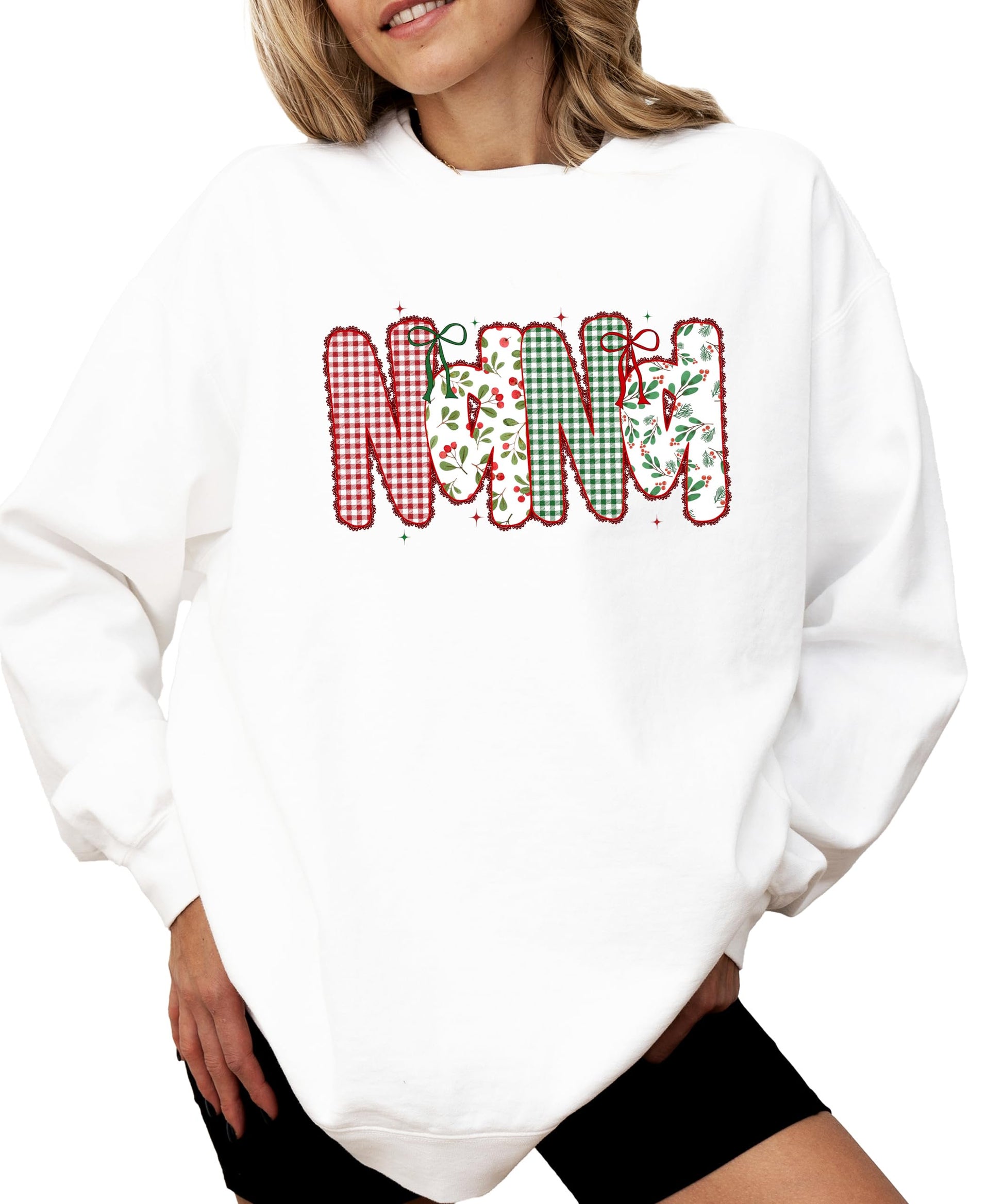 Close-up of festive red and green lace ink-print graphic on women's Christmas sweatshirt