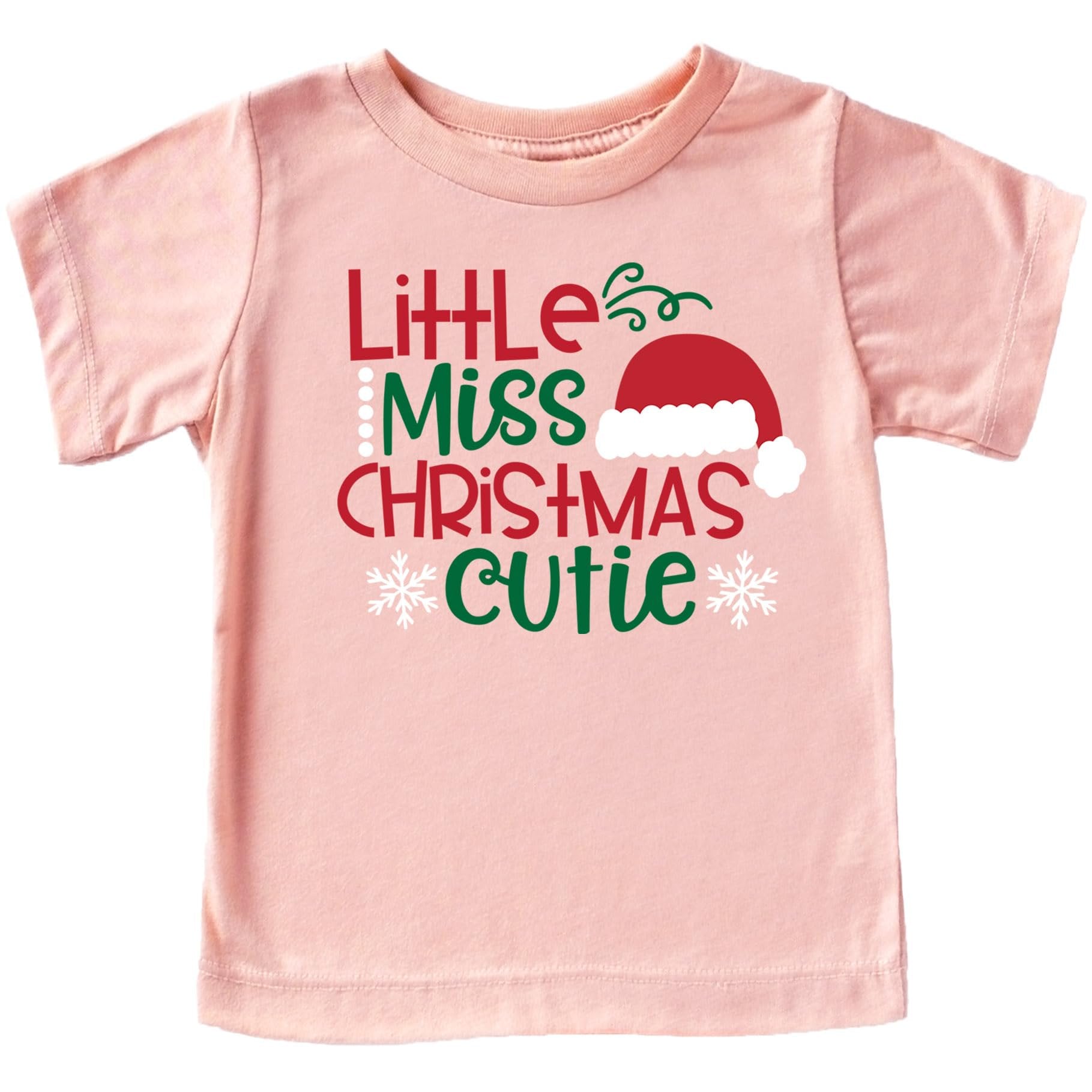 Close-up of Little Miss Christmas Cutie holiday graphic print on peach kids tee