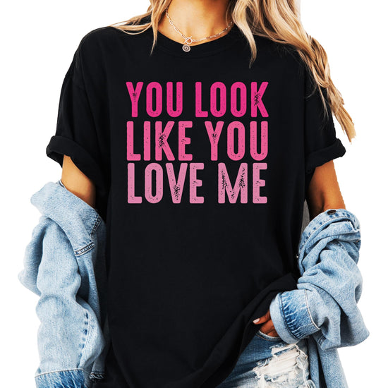 Women's black graphic tee with pink You Look Like You Love Me design laid flat