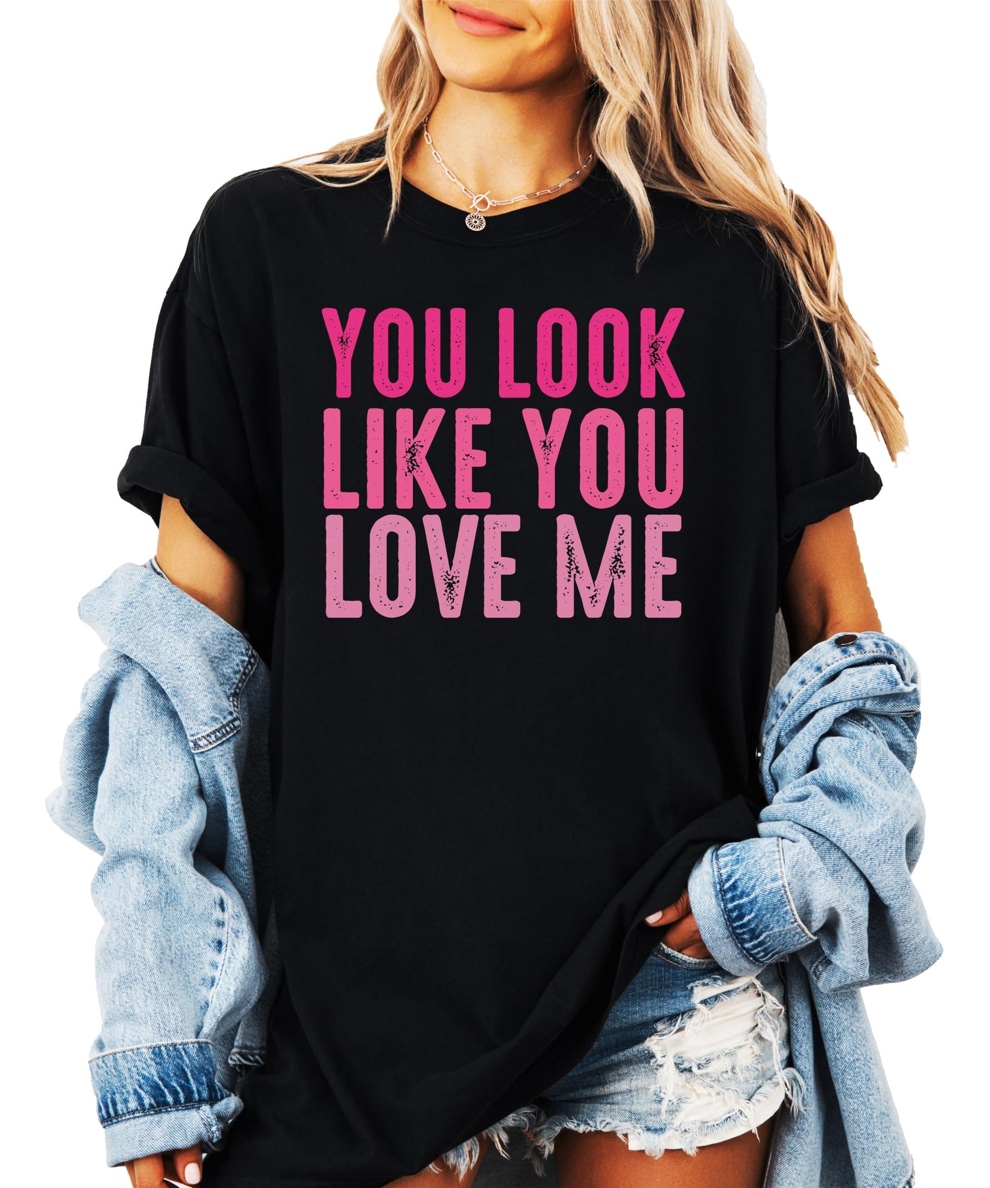 Women's black graphic tee with pink You Look Like You Love Me design laid flat