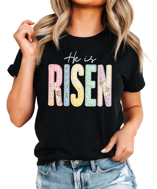 Front view of He Is Risen Easter shirt for women in pink with bold Christian graphic print