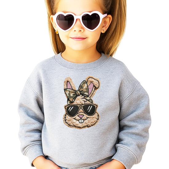 Close-up of ink printed Easter bunny with camo bow graphic on black pullover