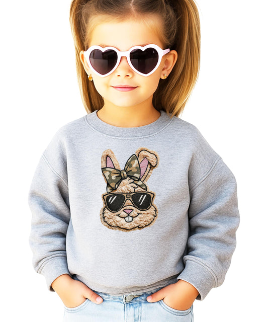 Close-up of ink printed Easter bunny with camo bow graphic on black pullover