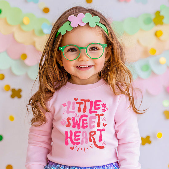 Side or detail view of cozy pink girls' Valentine sweatshirt from Olive Loves Apple