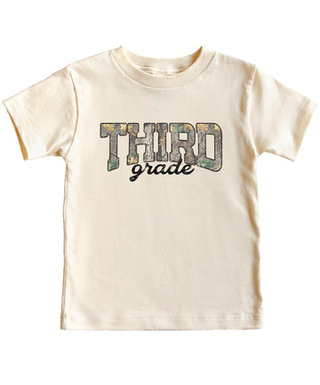 Boy wearing third grade camouflage shirt in military green for back to school