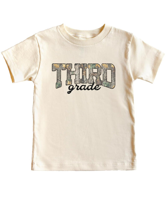 Boy wearing third grade camouflage shirt in military green for back to school