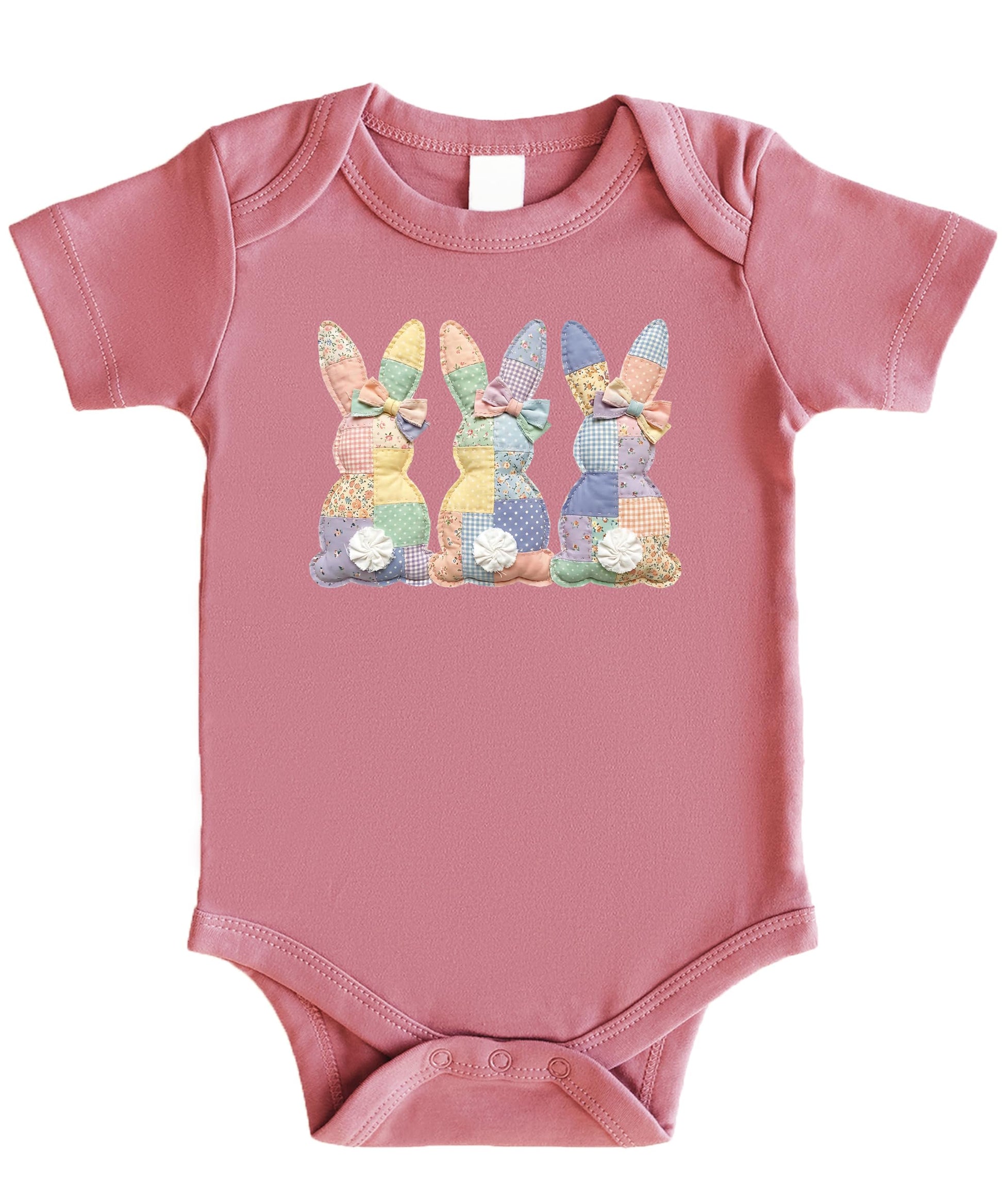 Close-up of ink-printed patchwork bunny design on a natural infant one piece bodysuit