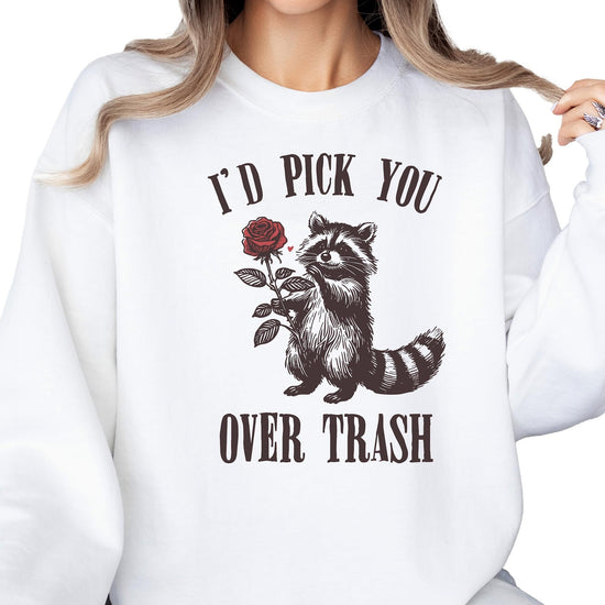Women's white Valentine's Day sweatshirt with humorous raccoon and rose design laid flat