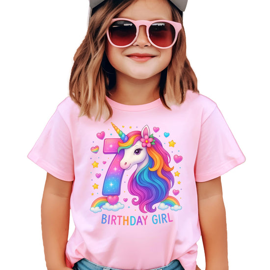 Side or back view of girls pink 7th birthday unicorn graphic shirt
